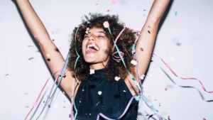 new-years-resolutions-ideas-person-celebrating-with-confetti